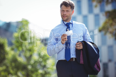 Businessman showing identity card badge