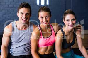 Happy female and male athlete in fitness studio