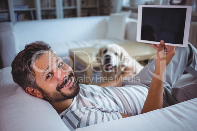 Man holding digital tablet in living room