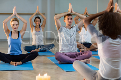 Instructor taking yoga class