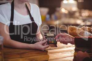 Customer entering pin number into machine at counter