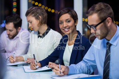 Businesspeople preparing document in office