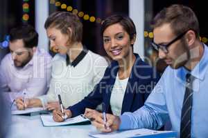 Businesspeople preparing document in office