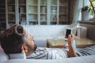 Man using his mobile phone in living room