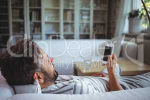 Man using his mobile phone in living room