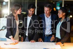 Group of businesspeople discussing over blueprint