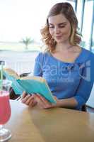 Woman reading a novel in the coffee shop