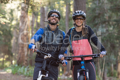 Biker couple with mountain bike in countryside