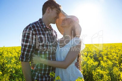 Romantic couple embracing each other in mustard field