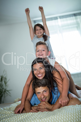 Happy family having fun in bedroom