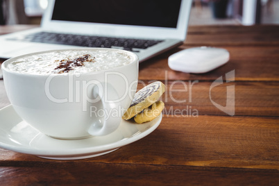 Coffee cup and cookies on a table