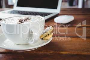 Coffee cup and cookies on a table