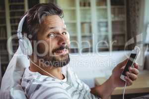 Smiling man listening to music on headphones