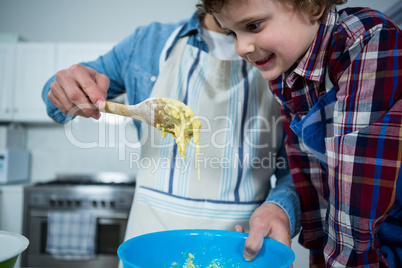 Father and son preparing cupcake