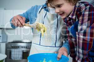 Father and son preparing cupcake