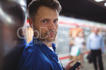 Portrait of handsome man listening song on mobile phone