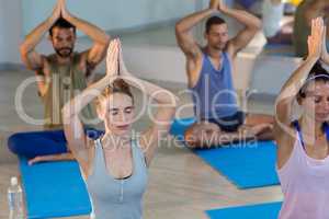 Group of people performing yoga