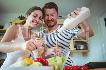 Family preparing salad in the kitchen