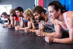 Serious friends exercising in gym