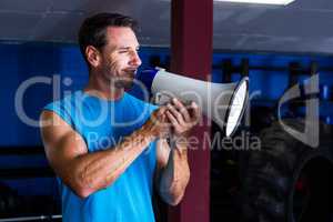 Smiling instructor holding megaphone