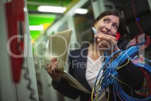 Technician holding internet cable while talking on phone