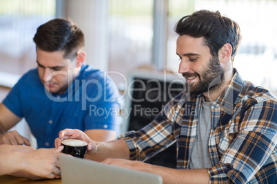 Waitress serving a cup of coffee to customer