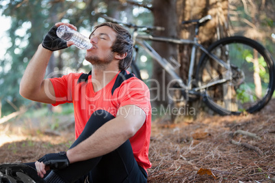 Male mountain biker drinking water