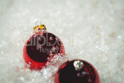 Close-up of christmas baubles on snow