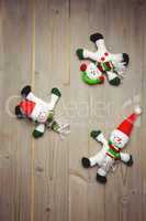 Santa claus and snowman on wooden table