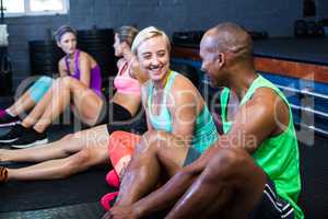 Athletes smiling while talking in fitness studio