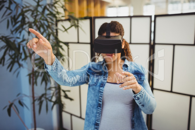 Businesswoman pointing while using virtual reality headset