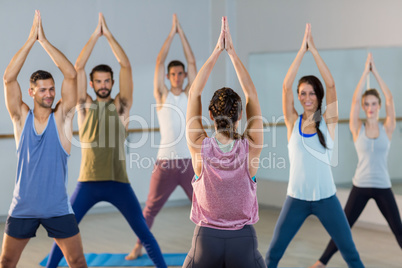 Instructor taking yoga class