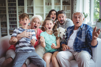 Happy family watching television in living room