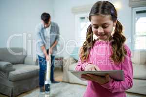 Girl using digital tablet in the living room