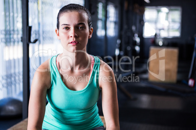 Confident athlete sitting in gym