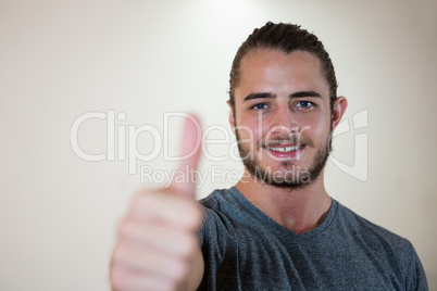 Portrait of smiling man showing thumbs up