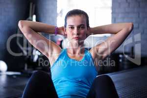 Portrait of serious female athlete in gym