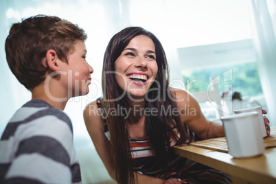 Boy whispering to his mother