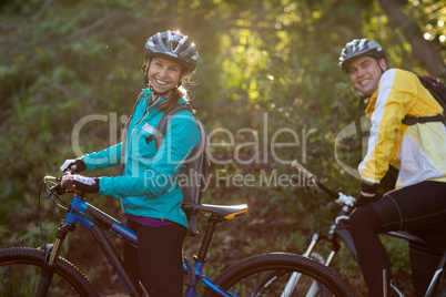 Biker couple with mountain bike in countryside