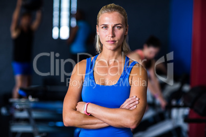 Portrait of serious woman with arms crossed in gym