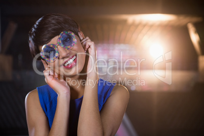 Woman wearing fancy sunglasses in bar