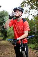 Male cyclist drinking water