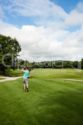 Rear view of man playing golf