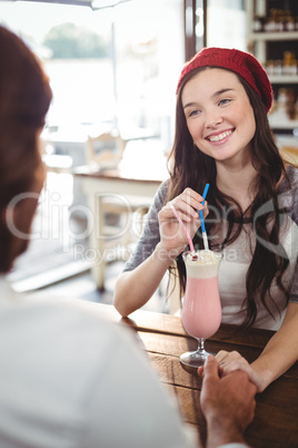 Couple drinking milkshake with a straw