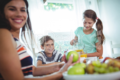 Smiling family having a breakfast