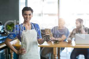 Portrait of waitress holding cup of coffee