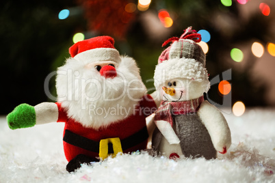 Santa claus and snowman on snow