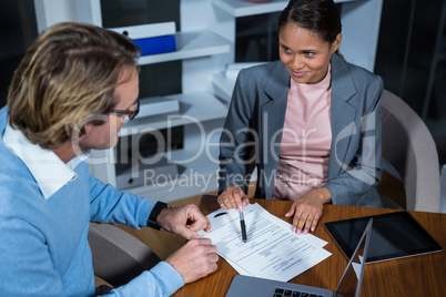 Businessman and businesswoman working in office