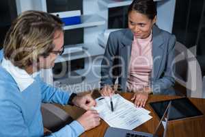 Businessman and businesswoman working in office