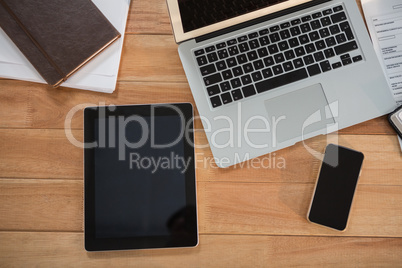 Laptop, digital tablet, mobile phone and organizer on desk
